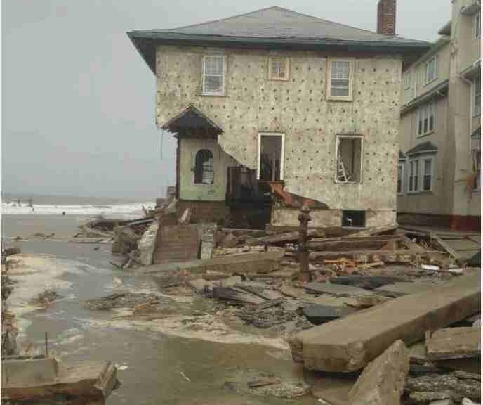 A heavily damaged house on the shore in Brooklyn, New York.